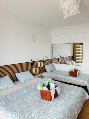a bedroom with two beds and a mirror at Apartmány Júlia in Živogošće