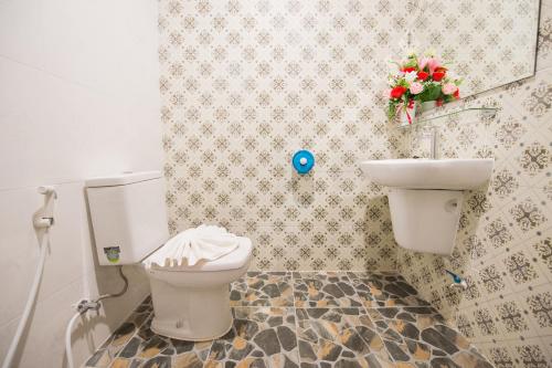 a bathroom with a toilet and a sink at Sri Siam Resort in Kanchanaburi City
