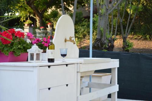 a white table with a wine glass and a surfboard at Villa Dacia in Guiglia