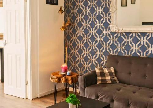 a living room with a couch and a table at Matchday Mile House Walk to Anfield sleeps 8 in Liverpool