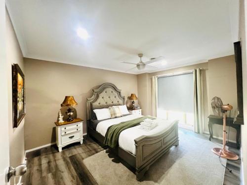a bedroom with a large bed and a window at Tarneit Treasure in Tarneit