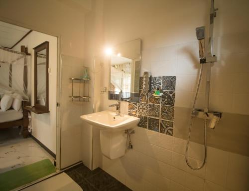 a bathroom with a sink and a shower at Suriya Homestay Mirissa in Mirissa