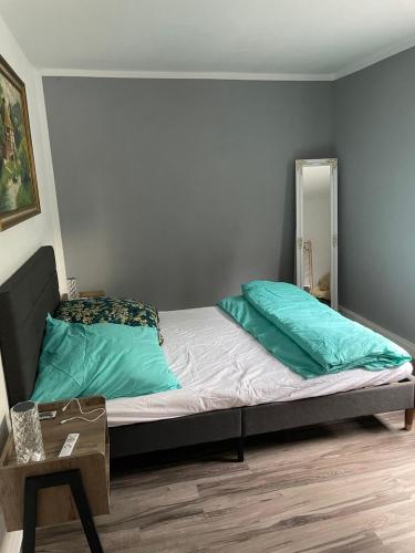 a bed with two pillows on it in a room at Mila's Fewo in Stollberg