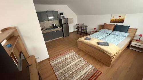 a small bedroom with a bed and a kitchen at My Central Home in Miercurea-Ciuc