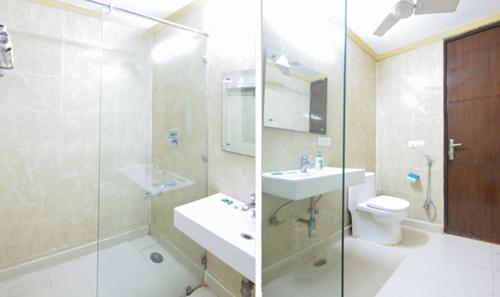 a bathroom with a sink and a toilet and a shower at The Hotel Am Bliss in Gurgaon