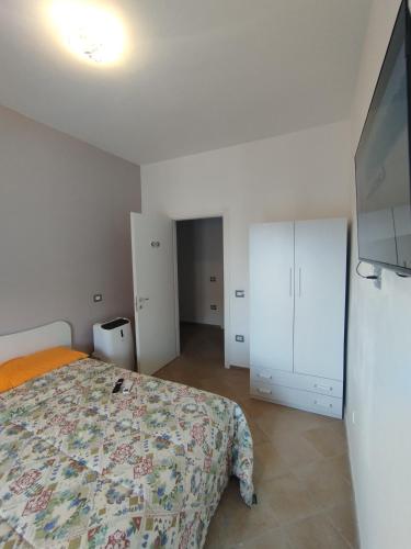 a bedroom with a bed and a flat screen tv at Mira Beach Casa Vacanze in Praia a Mare