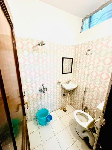 a bathroom with a toilet and a sink at Angel paradise in Jaipur