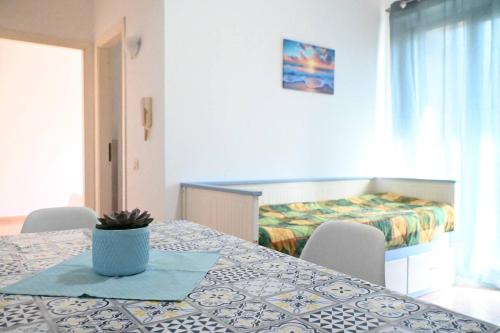 a room with a table with chairs and a bed at Casa Vacanze Zefiro in Marzocca di Senigallia