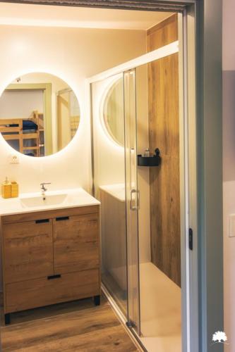 a bathroom with a shower and a sink and a mirror at Albergue La Incera in San Martín