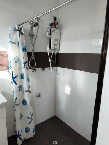 a bathroom with a shower with a shower curtain at Cozy Self-contained Unit in Lautoka