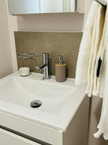 a bathroom sink with a faucet on top of it at The Kgale Luxe in Gaborone