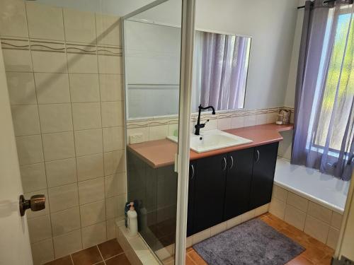 a bathroom with a sink and a shower at House in Ellenbrook in The Vines