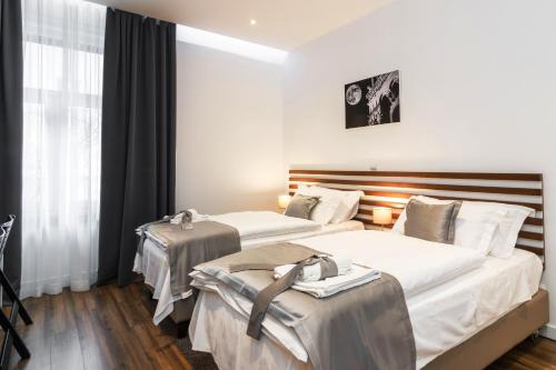 a hotel room with two beds and a window at Prima Luxury Rooms in Split