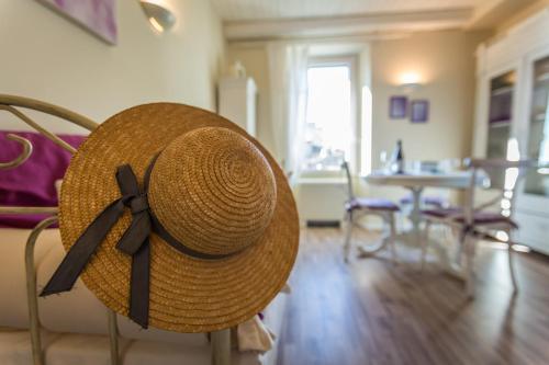 a straw hat sitting on a chair in a living room at Viterbo Antica - centro storico in Viterbo