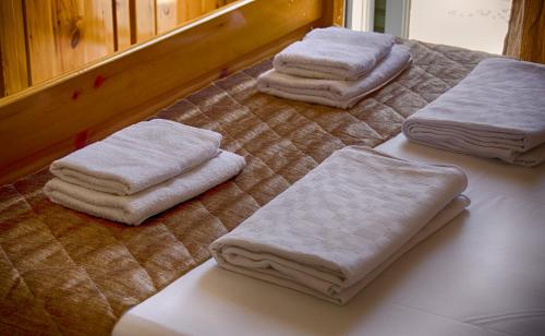 three towels sitting on top of a table at Galini Apartments in Olympiaki Akti