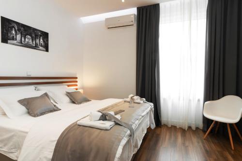 a bedroom with a bed with two towels on it at Prima Luxury Rooms in Split