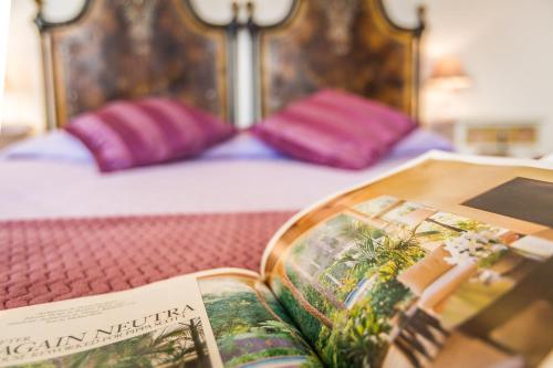 an open book sitting on a bed with at Viterbo Antica - centro storico in Viterbo