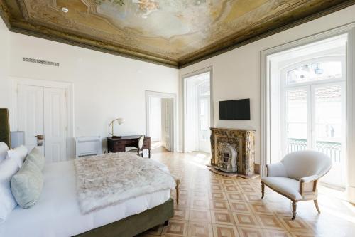 a bedroom with a large bed and a fireplace at Palácio do Visconde - The Coffee Experience in Lisbon