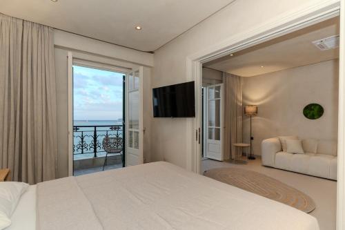 a bedroom with a bed and a view of the ocean at Bosi Suites 2 in Zakynthos