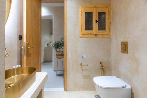 a bathroom with a toilet and a sink at Bosi Suites 2 in Zakynthos