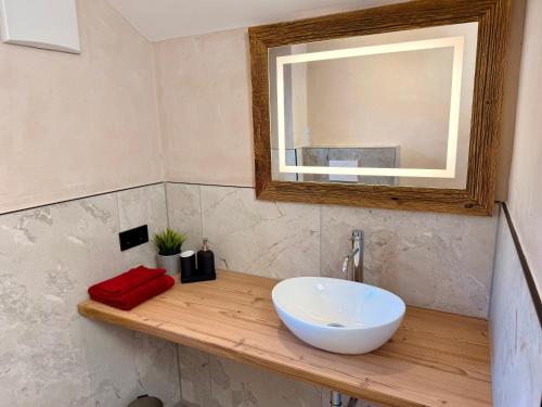 a bathroom with a white sink and a mirror at Das Lisal in Zell am Ziller