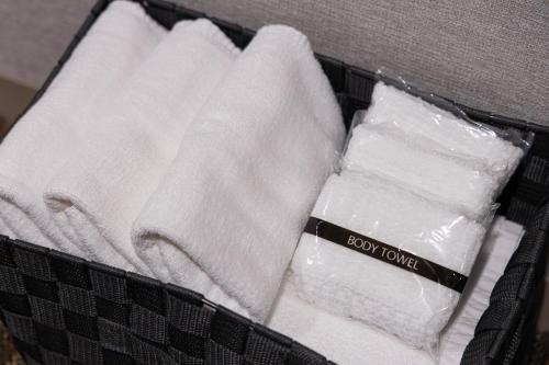 a basket of towels and a box of soap towels at Hotel Rose Garden Shinjuku in Tokyo