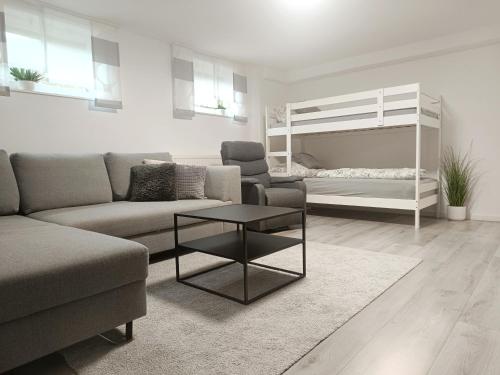 a living room with a couch and a bunk bed at Ferienwohnung Wagner in Bad Staffelstein