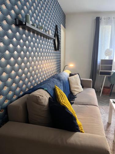 a bedroom with a bed with a blue wall at Le Bretonneau Ledru Rollin in Tours