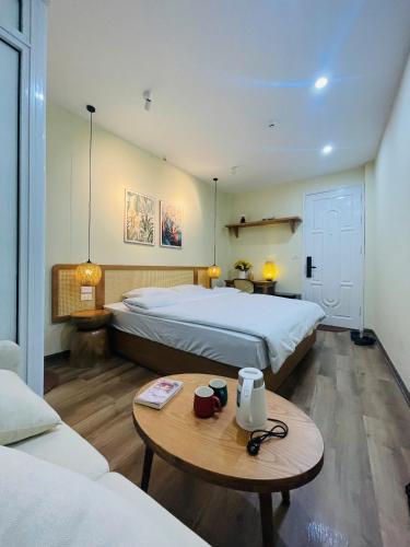 a hotel room with two beds and a table at Silk Homestay LVC Central in Hanoi
