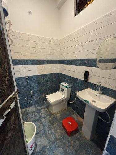 a bathroom with a toilet and a sink at Seeta Palace in Ayodhya