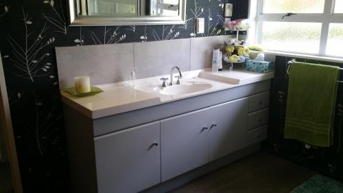 a bathroom with a sink and a mirror at Korbaylen Estate in Hamilton