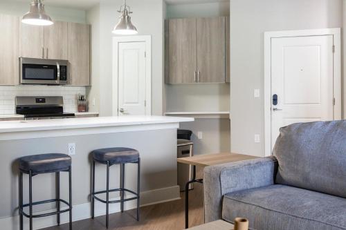 a living room with a couch and a kitchen at Landing Amazing 1BD Gym Clubhouse in Fort Myers