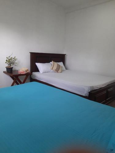 two beds sitting next to each other in a room at AIRA in Galle