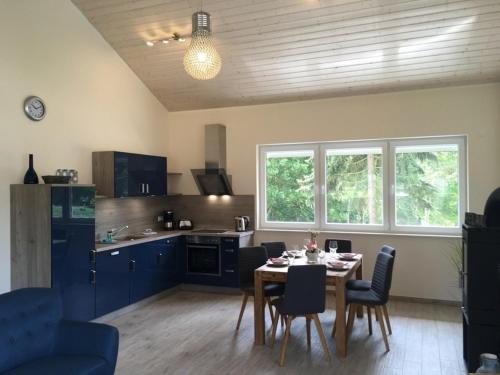a kitchen and dining room with a table and chairs at Kerstin in Lenz