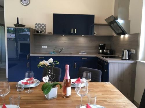 a kitchen with a table with wine bottles and glasses at Kerstin in Lenz