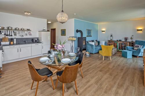 a kitchen and living room with a table and chairs at Lago EG in Lenz