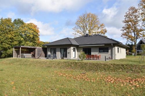 a white house with a black roof on a yard at Michael in Lenz
