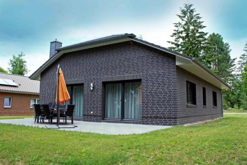 a house with chairs and an umbrella in front of it at Valentina in Lenz