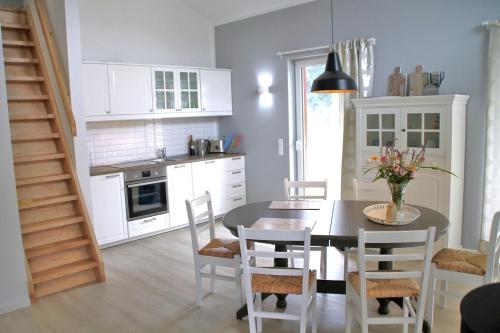 a kitchen with a dining room table and chairs at Trine in Lenz