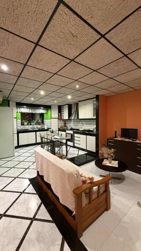 a room with a bed and a kitchen with tables at Flat 3 in Mġarr