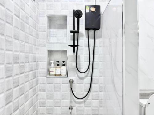 a shower with a blow dryer in a bathroom at Labelle villa koh phangan in Ko Phangan