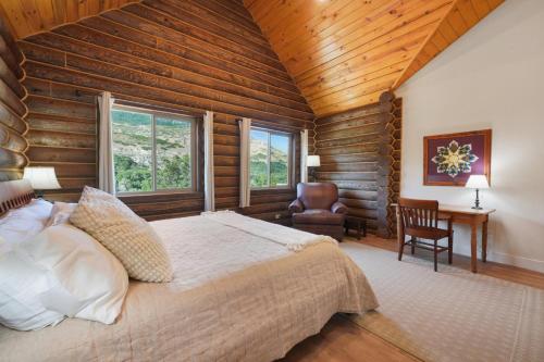 a bedroom with a large bed in a room with wooden walls at Cute Cabin with Mountain Views and King Bed in Provo