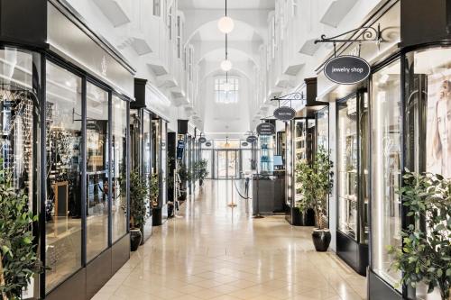 a hallway of a store with potted plants at Villavejle Hotel, BW Signature Collection in Vejle