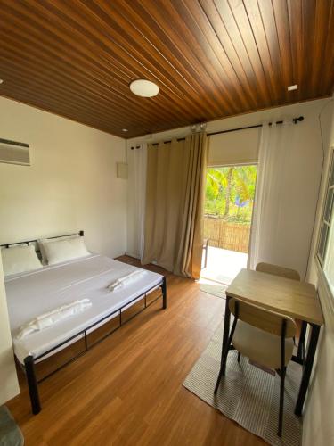 a bedroom with a bed and a wooden ceiling at L & Ev Be My Guest in San Juan