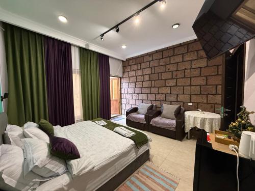 a bedroom with a bed and a couch in it at Sunny Village Hotel in Haghpat