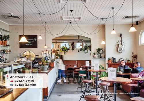 a restaurant with people sitting at tables in a room at Waterfront High Rise 5 Beds 2 Car Parks in Sydney