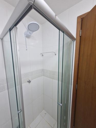 a shower with a glass door in a bathroom at Flat com 1 quarto e sala in Goiânia