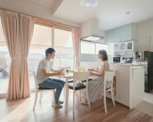 a man and woman sitting at a table in a kitchen at Private stay Peaceful - Vacation STAY 18247 in Minamiawaji