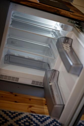 an empty refrigerator with its door open with its door at Spring Tide Cliff Top Glamping Pod with direct Sea Views in Birchington