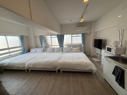 a large bed in a room with a large window at HOTTOSTAYman401 in Sasashimachō